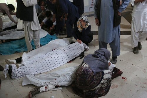 Afghans begin burying dead from bloody school blasts