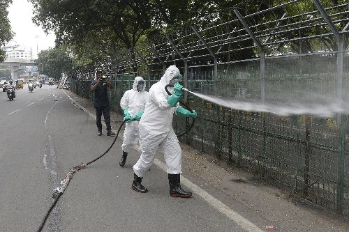 India locks down capital to battle virus as US hits vaccine milestone