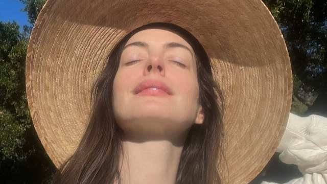 Anne Hathaway Almost Pops Out of Plunging Saint Laurent Striped Suit