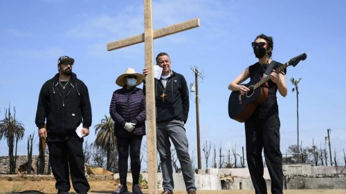 Members of burned LA church bear a cross through their devastated neighborhood to mark Good Friday