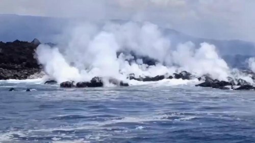 Lava flow from volcano on an uninhabited Galapagos island reaches ocean