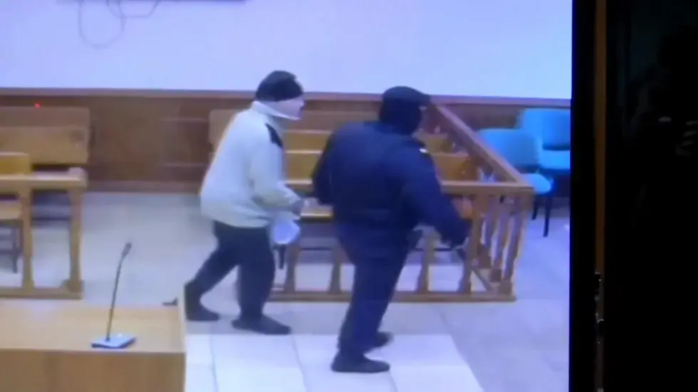 Image from AP's coverage: Sister of American held in Russia says he didn't know he was being released until he saw US flag