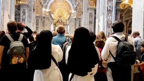 A young nun says goodbye to Francis after hours in line with thousands of faithful
