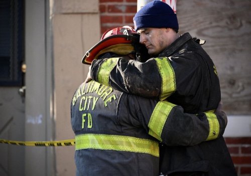 Three firefighters rescued, one still trapped in Southwest Baltimore blaze, officials say