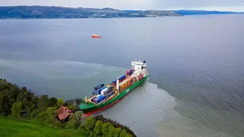 Man in Norway wakes to find huge container ship in garden