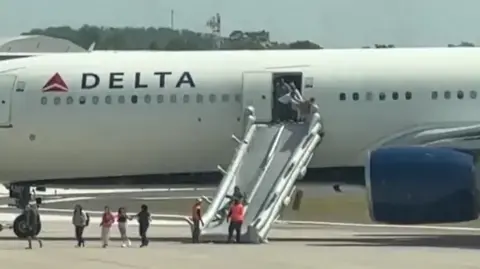 Passengers evacuate Delta plane after engine fire