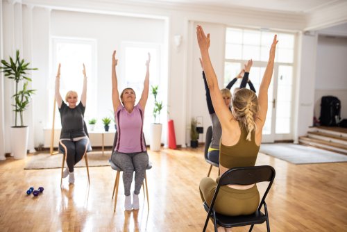 Chair Yoga Is the New All-Ages Fitness Trend That Can Make You Look and Feel Younger