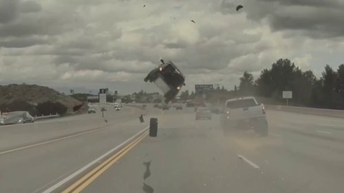 Car goes airborne on Los Angeles freeway after tire pops off pickup truck: video