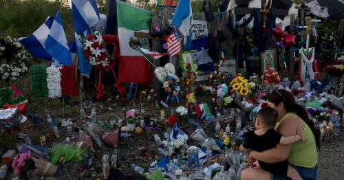 Mourners honor the 53 lives lost with flags, candles, flowers — and water