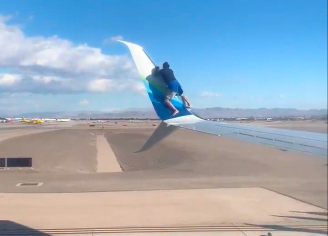 Guy climbs on wing of plane just before takeoff. It doesn't end well.
