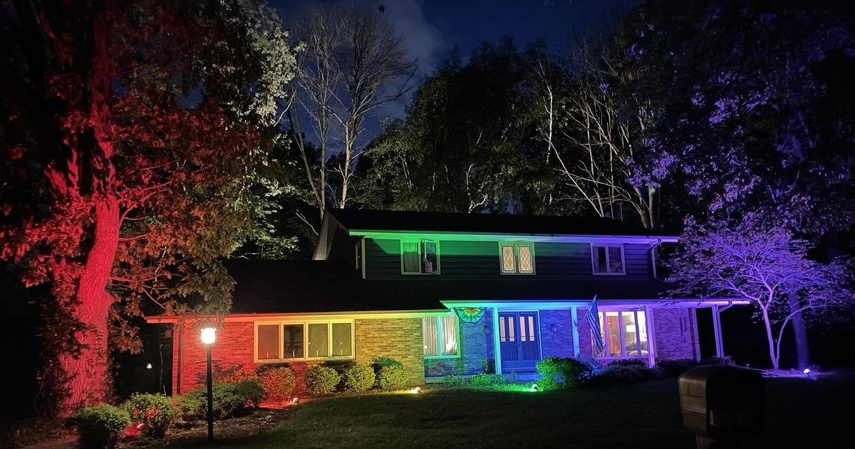 They weren't allowed to fly their pride flag, so this couple lit up their home with a rainbow light display
