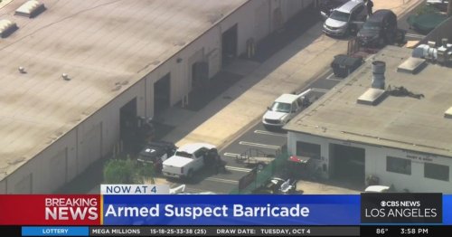 Armed suspect barricaded inside warehouse in Costa Mesa