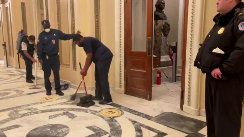 The jarring, revealing video of Black men cleaning up the Capitol