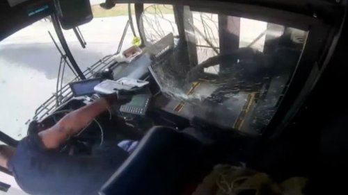 Surveillance footage shows bus driver and passenger in shootout aboard moving bus