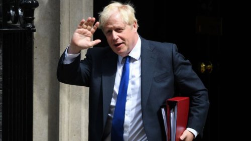 Boris Johnson clings to power after dozens of British lawmakers resign and urge him to quit