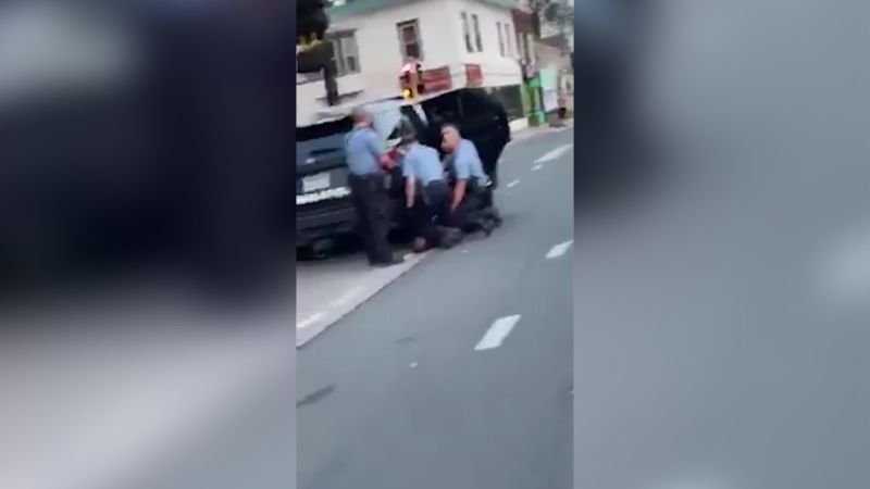 New video appears to show three police officers kneeling on George Floyd