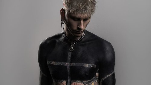Machine Gun Kelly gets "spiritual" blackout tattoo on upper torso