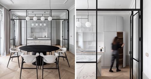 A Black-Framed Glass Wall Separates The Kitchen From The Dining Room In This Apartment