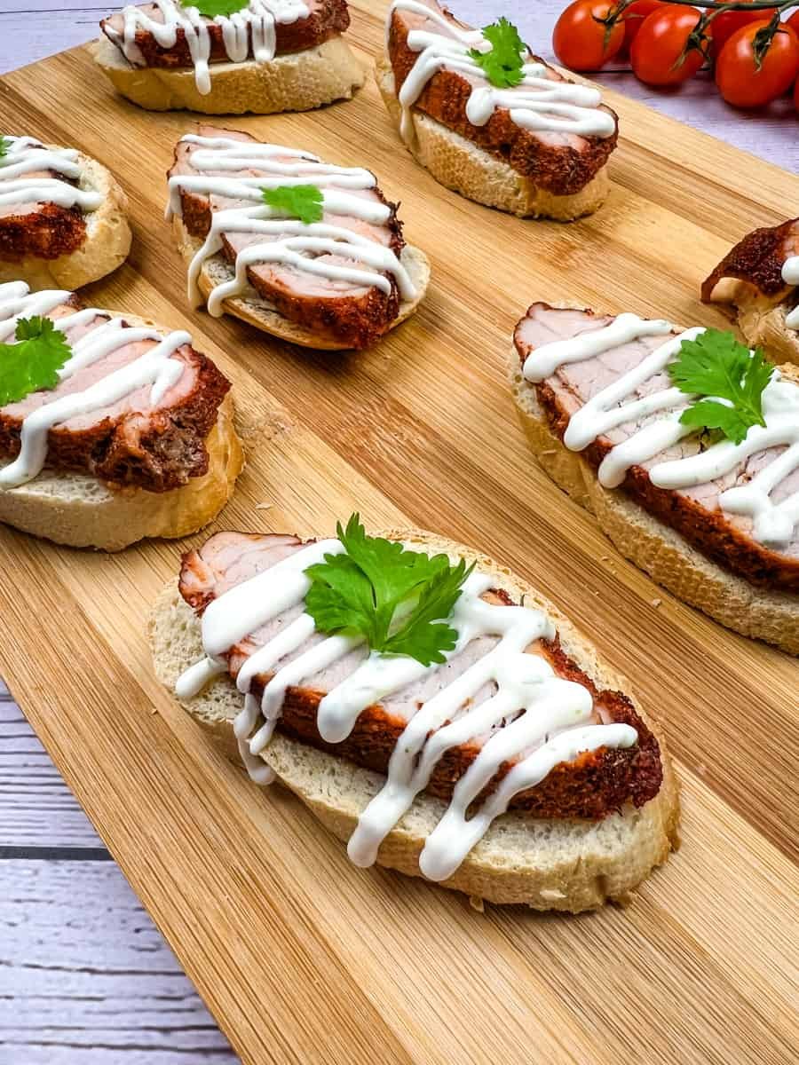 Spicy Pork Tenderloin Crostini with Lime Crema - Cook What You Love