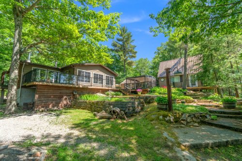 $899K for a Muskoka Lakes cottage with a sunroom, bunkie, and workshop