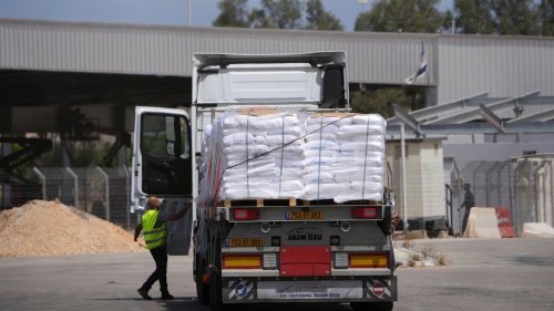 First aid trucks enter Gaza after Israeli blockade, but UN warns it is a 'drop in the ocean'