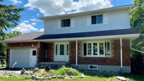 Ontario couple who bought home in winter finds garbage dump in backyard when snow melts