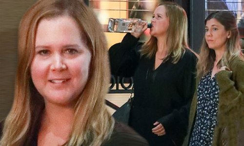 Amy Schumer swigs a bottle of alcohol while filming new Hulu series