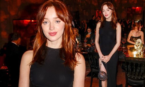 Phoebe Dynevor is the picture of sophistication in black gown with daring slit as she attends Moet Effervescence Dinner in Berlin