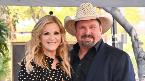 Trisha Yearwood and Garth Brooks put on a brave face at Hollywood Walk of Fame after considering leaving the US