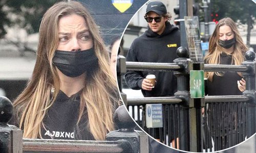 Margot Robbie dons an Anthony Joshua hoodie as she takes the tube in London with husband Tom Ackerley