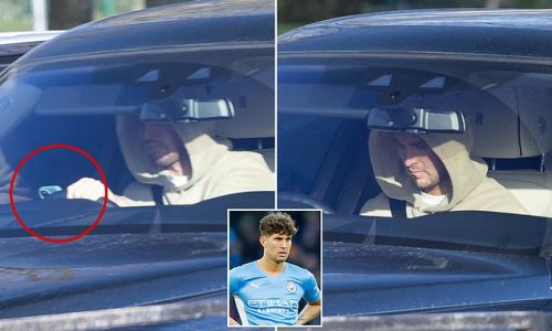 John Stones is caught using phone at the wheel of £400,000 Rolls Royce