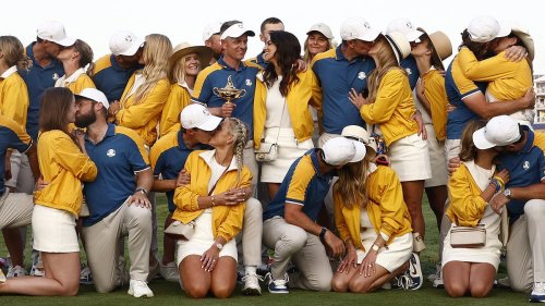 Jubilant Ryder Cup wags plant kisses on their victorious Team Europe partners after emotional Rory McIlroy led them to victory over 'cheat' Americans