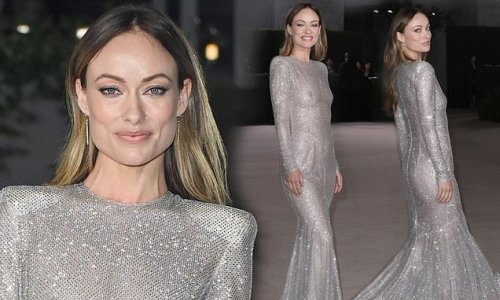 Olivia Wilde goes braless under a dazzling sheer silver feather trim ...