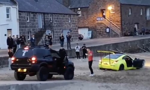 Supercar towed from beach after 'muppet show-off' driver gets stuck