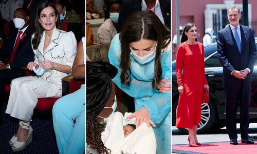 Queen Letizia of Spain covers her white suit with overalls and dons a face mask as she visits mothers and babies at a health facility in Angola