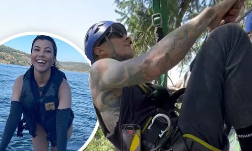 Travis Barker jokes that he 'used to be afraid of heights' as he zip-lines through a forest while vacationing in nature with wife Kourtney Kardashian