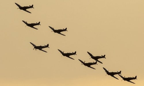 Nine Spitfires fly over stunned spectators in perfect formation during Battle of Britain air show