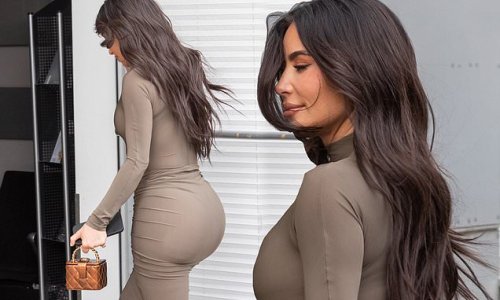 Kim Kardashian highlights her famous backside in a skintight beige dress as she jets out of Berlin after attending private equity conference