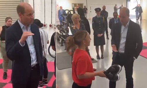 One fancies a spar! Prince William meets 'really impressive' female amateur boxer during a visit to...