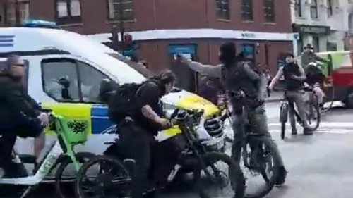 Shocking moment balaclava wearing bike gang prevent police van from attending a 999 call in London