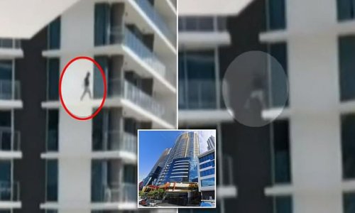 Heartstopping moment a man risks death by climbing between balconies on a high rise apartment building 24 STOREYS above the ground