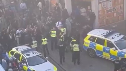 Moment dozens of armed police swarm Bradford city centre to tackle mass brawl after group of teenagers 'in balaclavas' charged at officers outside court