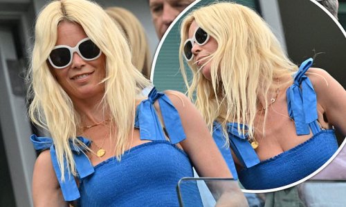 Claudia Schiffer, 51, looks effortlessly chic in an eye-catching blue dress as she watches Chelsea take on Tottenham Hotspur at Stamford Bridge