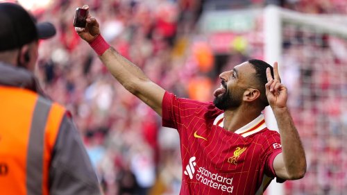 Mohamed Salah takes a SELFIE with fans after scoring in Liverpool's title-clinching rout of Tottenham at Anfield
