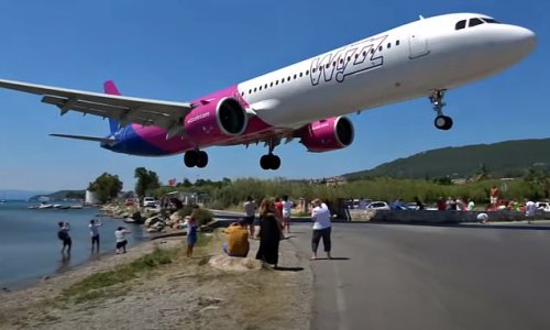 Heart-stopping video shows Wizz Air passenger jet skimming just yards over tourists' heads in 'lowest ever landing' at Greek island airport