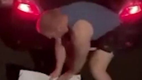 Top surgeon is filmed tearing down female MP's election poster in shocking late night rant: 'Go Trump'