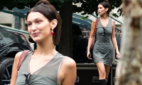 Bella Hadid wears a ruched olive minidress during Paris Fashion Week