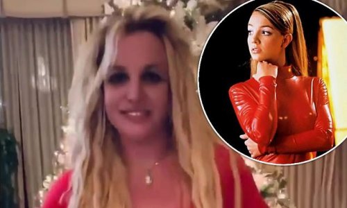 Oops she did it again! Britney Spears slips into a sexy red bodysuit as she recreates outfit from famous music video - amid speculation her social media is being controlled