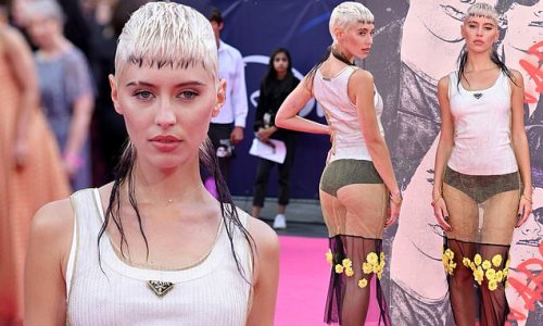 Iris Law puts on a VERY racy display as she flashes her peachy posterior in sheer dress and debuts edgy mullet at the Pistol premiere in London