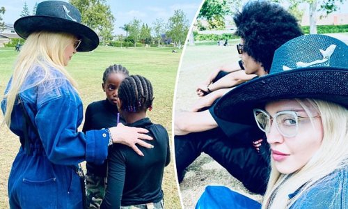 Madonna is a fashionable spectator at her son David's soccer match along with three of her daughters and boyfriend Ahlamalik Williams